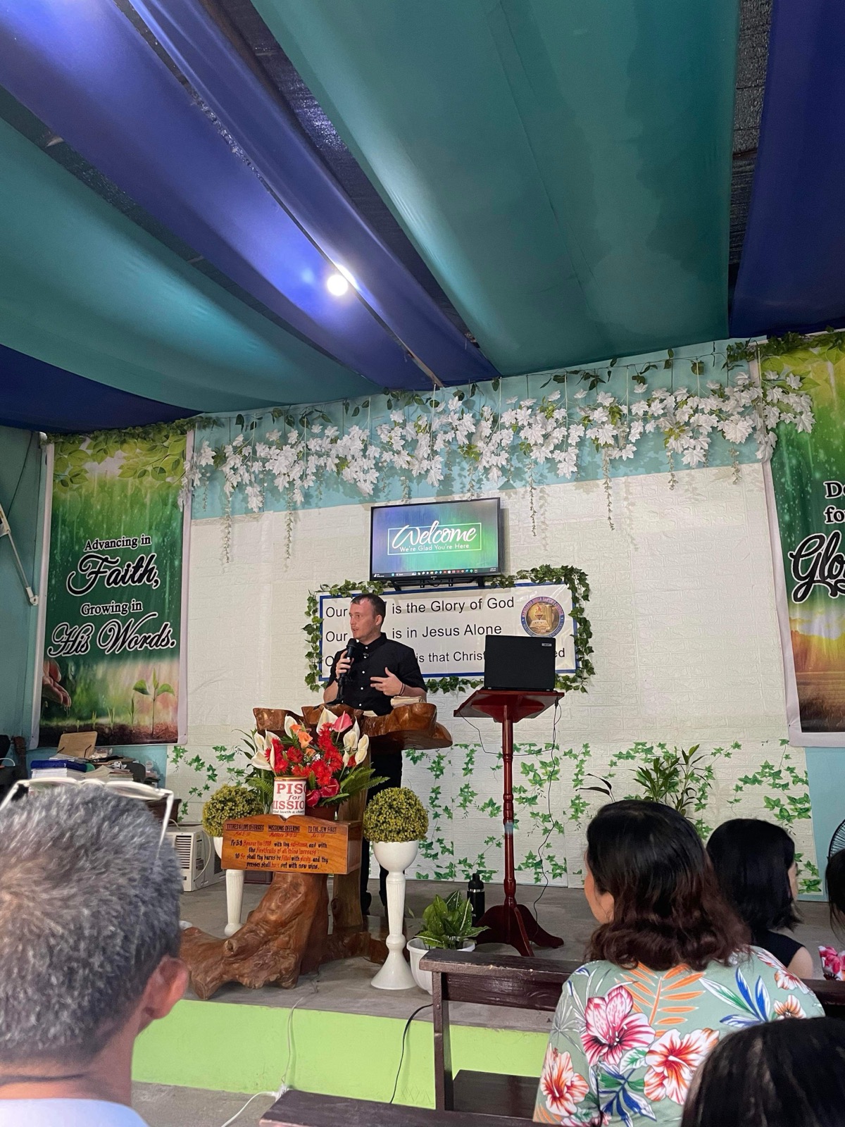 Collin preaching from the pulpit of a Filipino Baptist church on the field