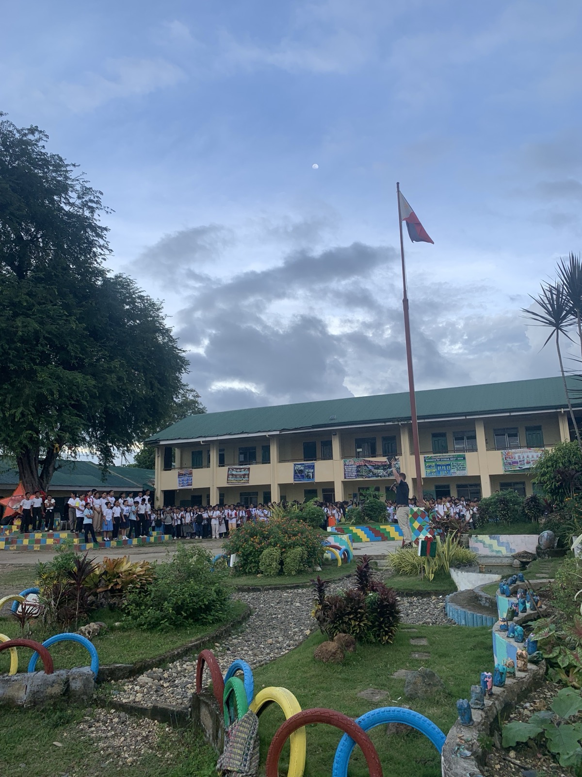 Hundreds of Filipino public high school students assembled outside their school building at flag ceremony